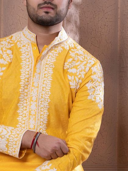 A close-up of the sleeve and placket embroidery on the zesty yellow kurta.