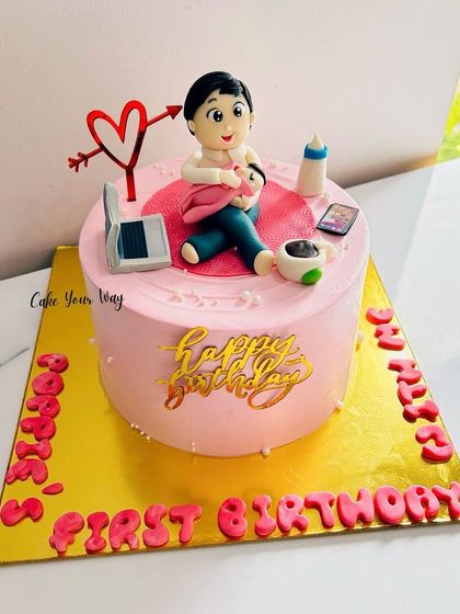 A special cake for a dad's first birthday with his baby, showing all the new parent essentials.