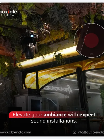 Expert sound installation can elevate any ambiance. Here, we integrated speakers and subtle lighting within a restaurant's green, biophilic design, proving that powerful audio can be discreet and blend seamlessly into a sophisticated environment.