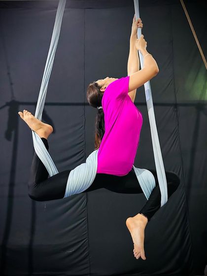 A beautiful backbend pose held with the support of the hammock, which helps to open the heart and improve spinal flexibility.