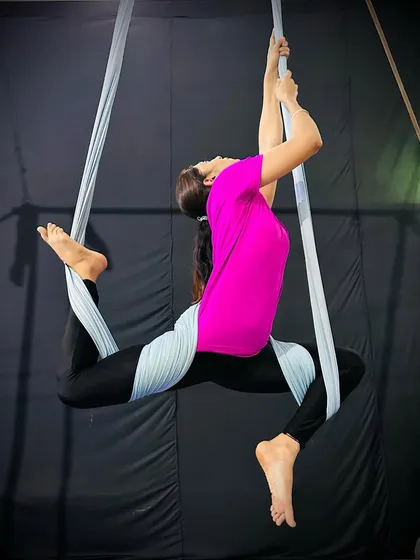 A beautiful backbend pose held with the support of the hammock, which helps to open the heart and improve spinal flexibility.