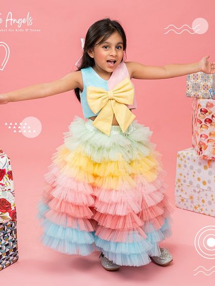 A joyful pose in our rainbow outfit, ready for a party.
