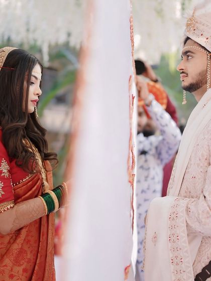 The Antarpat moment, a significant ritual in a Maharashtrian wedding. The bride and groom see each other for the first time, and her look is designed to be unforgettable.