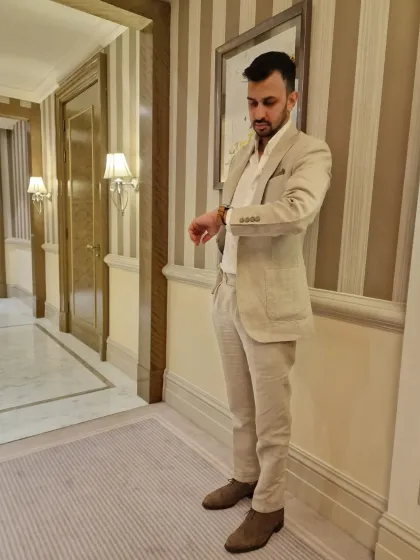A client looking sharp in a custom-tailored beige linen suit. This image demonstrates my focus on using the finest fabrics to create pieces that embody comfort, durability, and style.