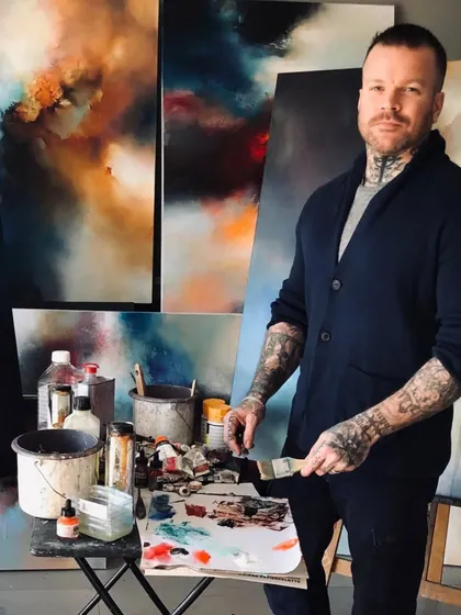 We are proud to collaborate with internationally acclaimed artists like Simon Kenny. This photo captures him in his studio, surrounded by the 'lyrical abstraction' works that have captivated collectors worldwide and which we were honored to showcase in his 'Mystic Mirage' solo show.