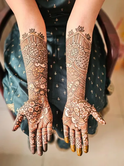 A lovely bridal design with a central mandala and floral patterns filling the rest of the hand.