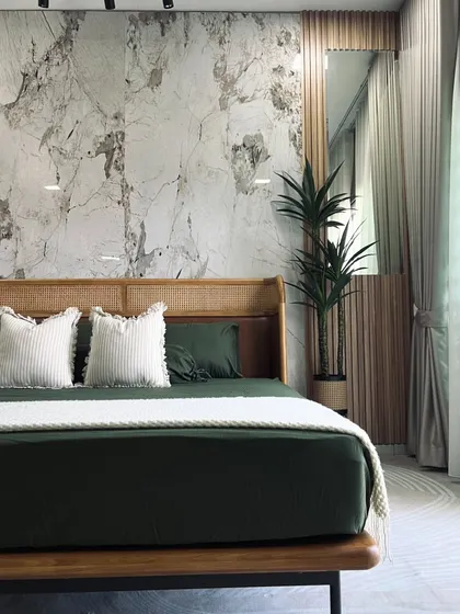 Create your personal retreat with the Tierra Bed, seen here against a stunning marble wall. The headboard, crafted from solid oak, natural rattan, and genuine saddle nut leather, brings a touch of nature-inspired, desert-chic elegance to the bedroom, promising a serene and luxurious escape.