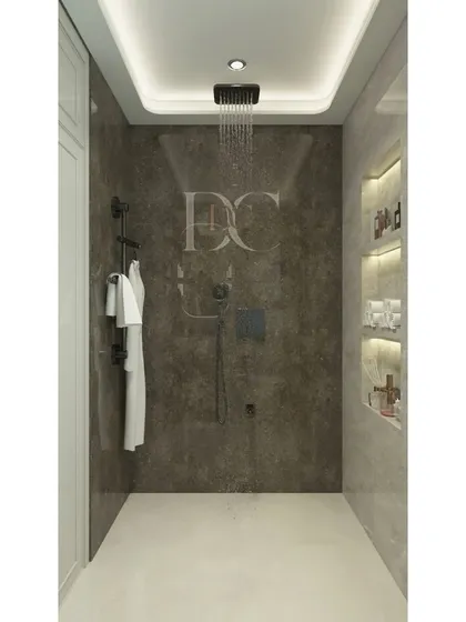 This image shows the shower area of the same bathroom, featuring a rain shower and built-in wall niches for toiletries. The consistent use of dark tiles creates a seamless and sophisticated look.