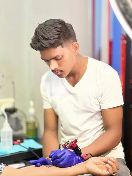 Artist Pravin focused on his craft. His steady hand and attention to detail are what make our tattoos stand out.