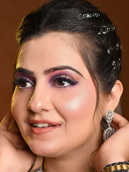 A close-up of the beautiful makeup for an engagement look, paired with our purple gown.