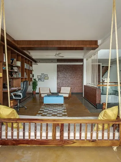 This multi-functional library and relaxation space was designed for a family of doctors to unwind. The traditional wooden swing, open shelving, and informal seating create a comfortable, personal area that is both practical and full of character.