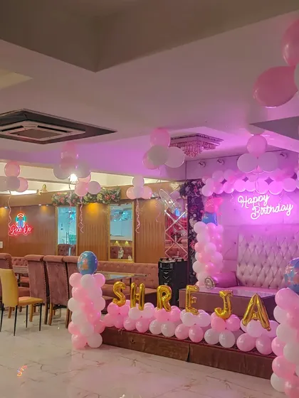 Another view of the pink and white first birthday party hall.