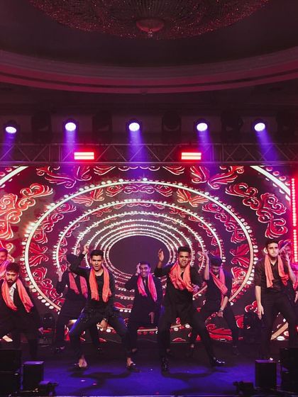 A high-energy groomsmen performance with a vibrant LED backdrop. I can help coordinate the visuals on screen to match the choreography and song.