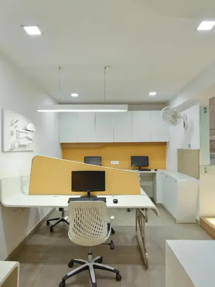 A view of the lower-level workstations in my studio. The space-saving layout and minimal furniture create a comfortable and efficient area for our junior team members, connected to the main floor by illuminated steps.