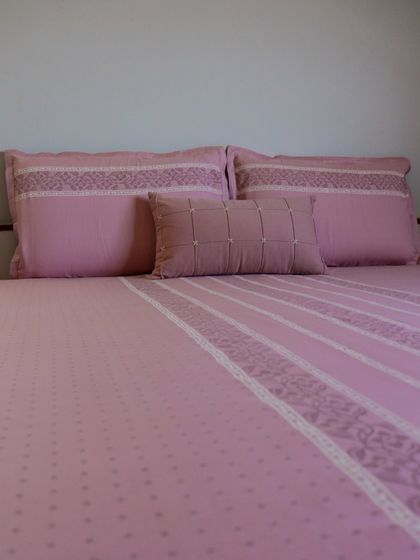 Our blush pink bedding set, crafted from soft cotton with delicate embroidered details. The subtle patterns and gentle color create a serene and romantic atmosphere, perfect for a peaceful night's rest.