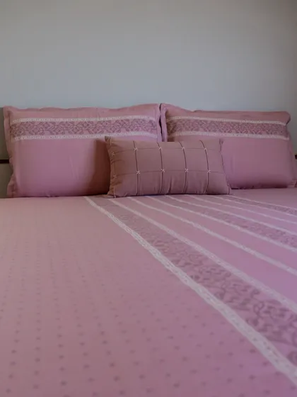 Our blush pink bedding set, crafted from soft cotton with delicate embroidered details. The subtle patterns and gentle color create a serene and romantic atmosphere, perfect for a peaceful night's rest.