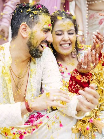 Pure joy and celebration. The couple is showered with flower petals, and their happiness is infectious.