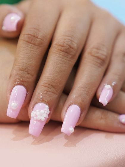 Timeless elegance with a modern twist. Our French gel nails feature a glossy finish and can be customized with delicate 3D floral charms for a touch of subtle glam.