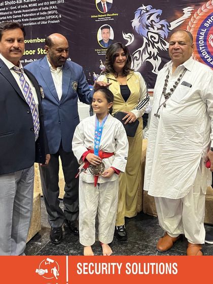 A young karate champion receives her medal from esteemed guests and our director. We are honored to host events that celebrate the achievements of young athletes.