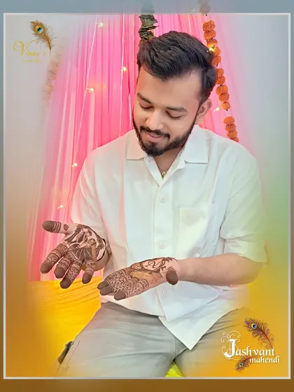 The groom admiring the final result of his personalized mehndi session.