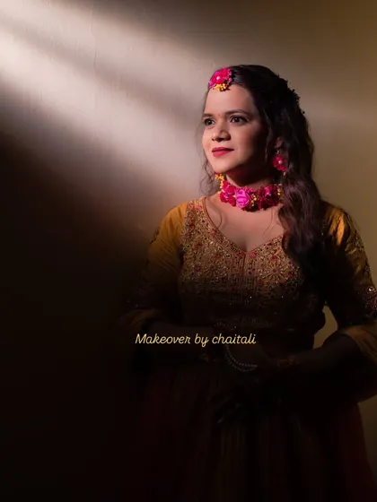 An artistic shot highlighting the soft and radiant makeup under dramatic lighting. The look is versatile enough for both candid and professional photoshoots.