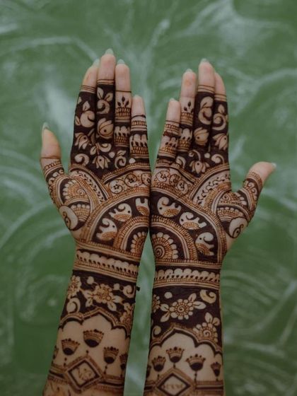 A beautiful back-of-hand design featuring a dense pattern of elephants and birds, perfect for an animal lover.