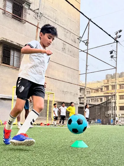 This player executes a quick turn around a cone, a drill designed to improve agility and reaction time with the ball at his feet.