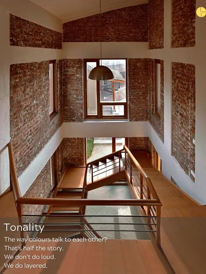 Tonality is half the story. We don't do loud; we do layered. This view in one of our projects shows how the warm tones of brick and wood talk to the cool white walls, creating a balanced and harmonious composition.