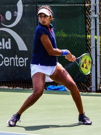 In her ready stance, Sahaja prepares for the next point, demonstrating the athletic poise required for high-stakes matches.