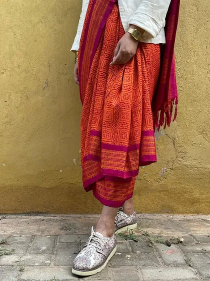 We believe in giving beautiful textiles a second life. This image showcases our overprinting service, where we take a pre-loved vintage Kanjeevaram silk saree from our founder's personal collection and refresh it with a vintage 'chunadi' block print.