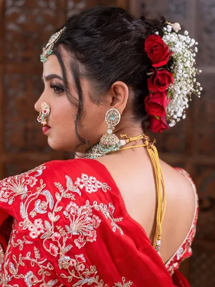 Another angle of the floral bun and the intricate details of the bridal blouse and jewelry.