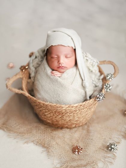 Tiny dreams in soft neutral tones. The sleepy hat and cozy wrap make this little one look so comfortable and content in a simple basket.