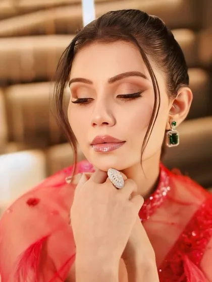 A detailed shot of the eye makeup for this cocktail look. A subtle winged liner and soft brown shadows create a look that is both elegant and alluring.