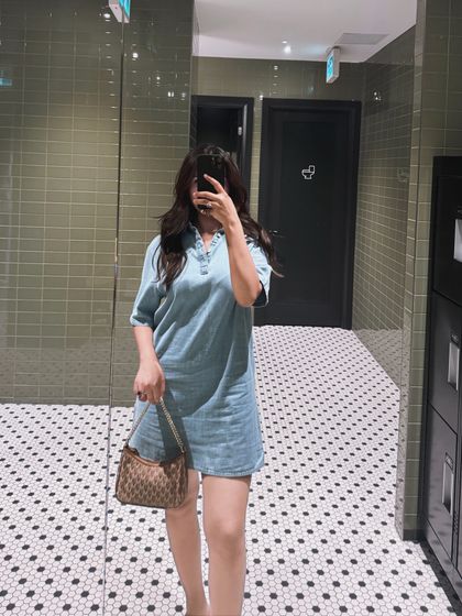 A mirror selfie of the denim dress outfit, providing a clear view of the look.