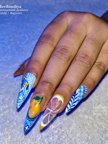This full-hand view displays the cohesive design of the citrus-themed nail art, combining patterns and fruit illustrations for a stunning summer look.