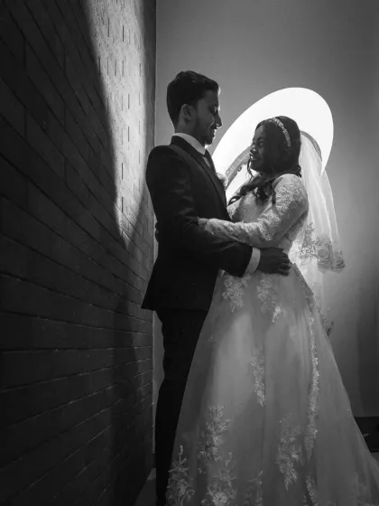 A dramatic black and white wedding portrait using creative lighting. This shot has a moody, cinematic feel, perfect for couples who want something different.