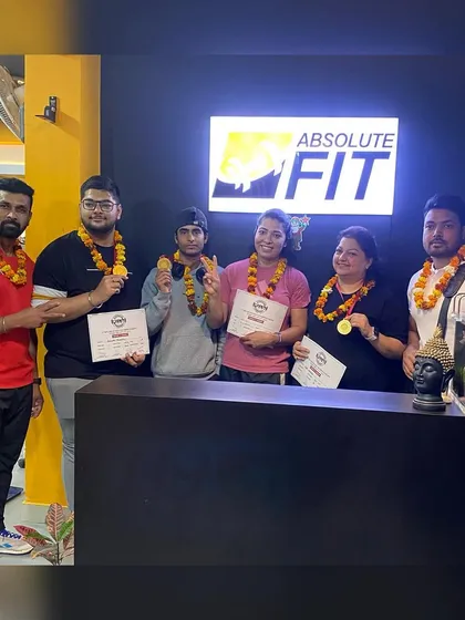 A group of our victorious powerlifters celebrating together. This image perfectly captures the team spirit and shared success that defines our Fit Fam.