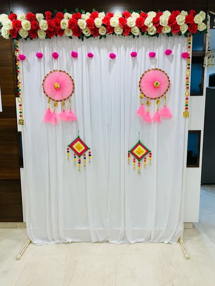 My services also cover traditional and religious functions. For this Updhyan ceremony, I created a clean and elegant backdrop using a white curtain, a floral border of red and white roses, and handmade decorative hangings.
