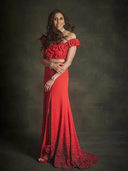 For an evening celebrating love, we wanted an ensemble that was both elegant and comfortable. This breathtaking red Valentino gown was the perfect choice. The intricate rose detailing on the bodice and the sparkling gradient on the skirt created a look that was pure romance and high fashion.