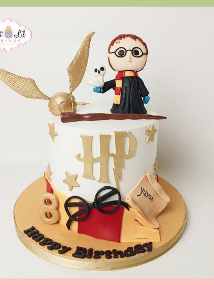 Magic is served with this enchanting Harry Potter cake. It features a handcrafted Harry figure with Hedwig, a golden snitch, and iconic symbols like the HP logo and glasses, all made from fondant for a truly magical birthday.