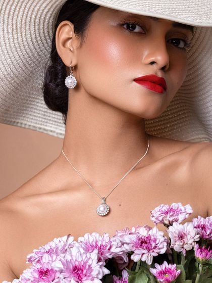 Another beautiful close-up, this shot emphasizes the flawless makeup and the elegant simplicity of the pearl necklace and earrings.