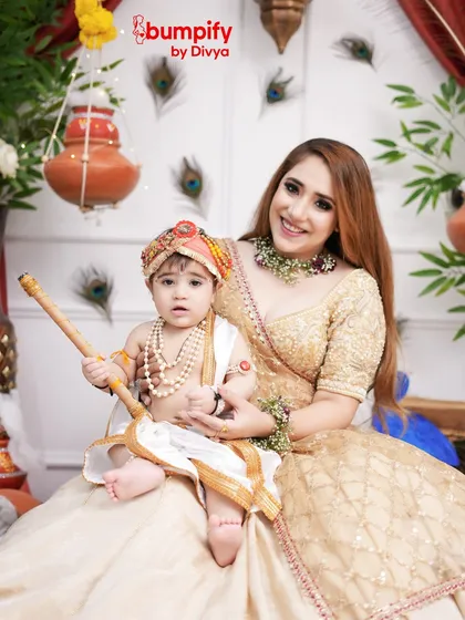 A closer portrait of the mother and her baby Krishna, capturing their sweet expressions and the intricate details of their festive outfits.