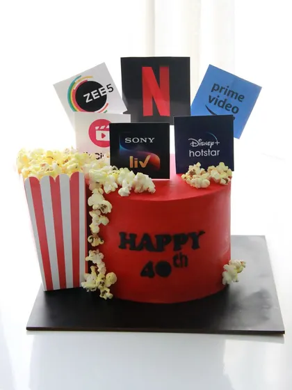 Netflix, cake, and chill. A fun 40th birthday cake for an OTT lover, featuring logos of popular streaming services and a box of popcorn.