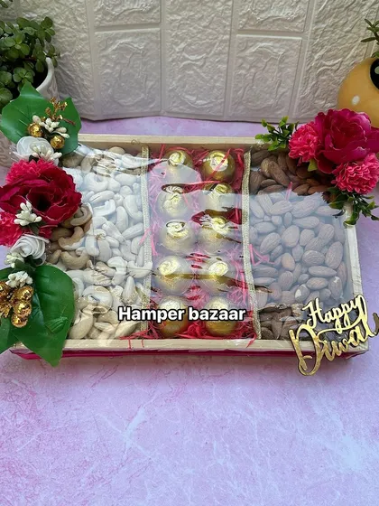 This dry fruit and chocolate hamper is a perfect mix of healthy and indulgent. The pinewood tray is divided into three sections, filled with cashews, almonds, and delicious chocolates.