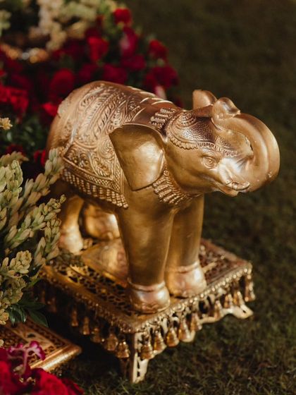 A detailed shot of a golden elephant statue, a symbol of luck and prosperity. This beautifully crafted piece was one of many traditional elements we used to add layers of meaning and elegance to the wedding decor.