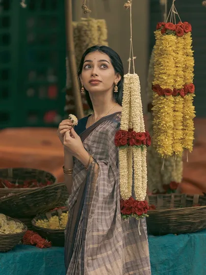 A candid moment during a stroll through Gandhi Bazaar, surrounded by the vibrant colors of flower garlands. This image reflects my ability to model in natural, everyday environments, creating authentic and relatable content for ethnic wear and lifestyle brands.