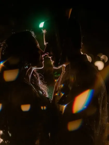 Night shoots allow for so much creativity. Using backlighting and a prism effect, I created this silhouette of the couple against the bokeh of city lights. It’s a dramatic and artistic way to tell a love story after dark.