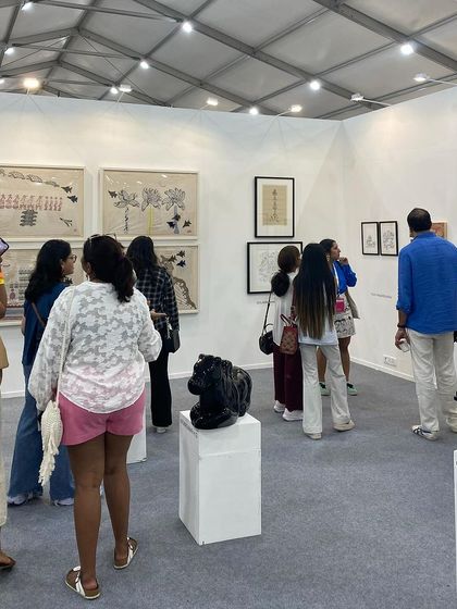 A group of young visitors exploring the art at our booth.