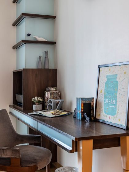 A simple yet elegant study desk in the Filigree House. The design is clean and functional, with built-in shelving that provides storage without adding clutter to the room.