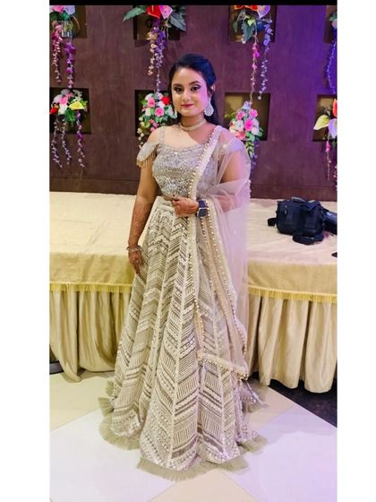 A client looking lovely in an ivory lehenga with a unique chevron pattern embroidery. This is a sophisticated choice for any party.